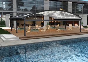 Large retractable pergola with an arched canopy beside a pool