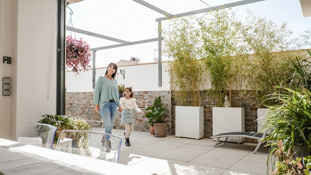 Daughter and granddaughter embracing the grandparents arriving at home