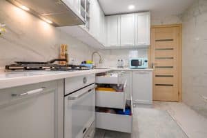 Small kitchen with pull-out drawers and white cabinets