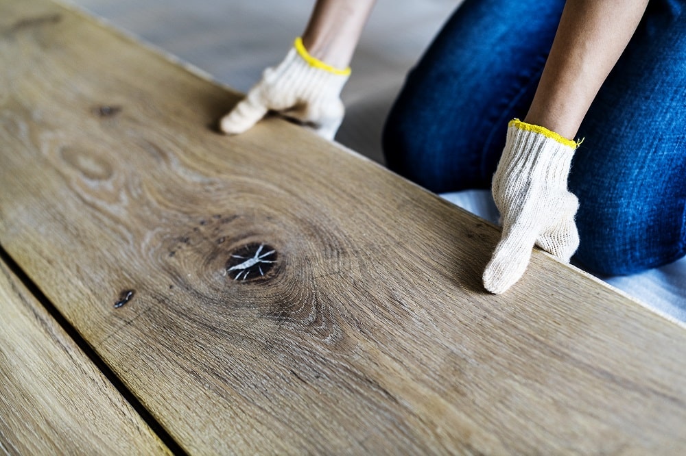 Carpenter man installing wooden floor