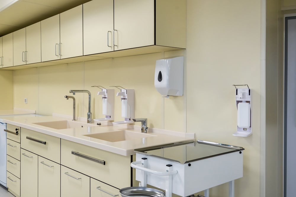 elbow soap and antiseptic dispenser or sanitizer wall mounted for hand disinfection and water tap sink with faucet bathroom or clinic