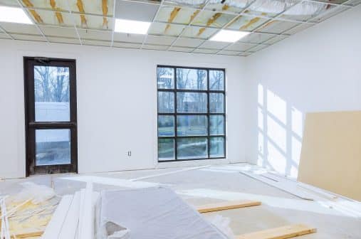 Making renovation of hung of suspended ceilings lights high in a bright modern office